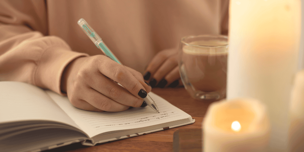 women writing in her journal to demonstrate the power of journaling for confidence