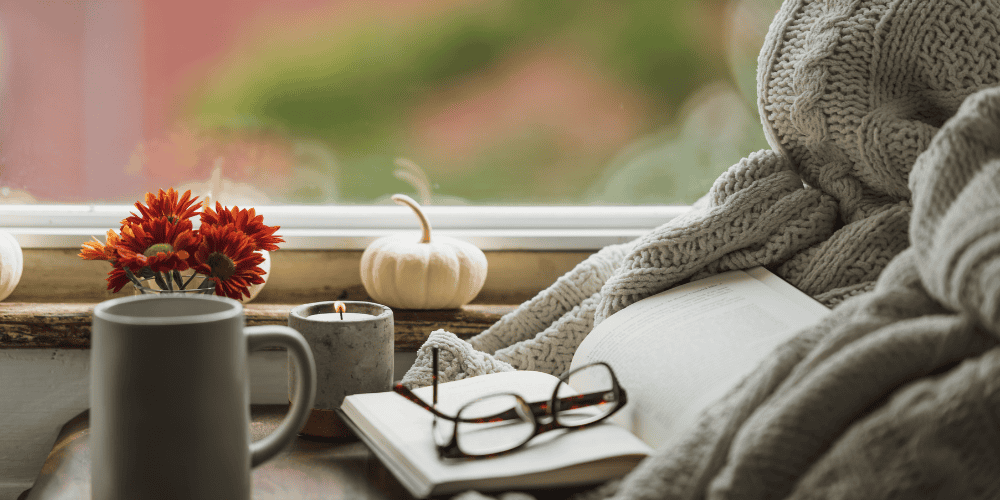 cozy fall picture with a journal to demonstrate doing a daily gratitude exercise