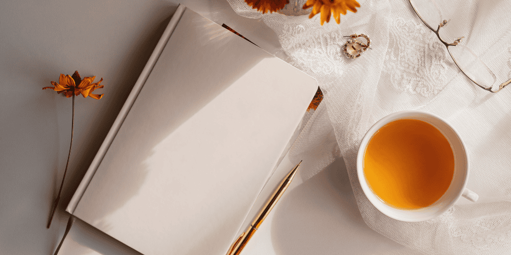 fall themed journal with a cup of tea to demonstrate doing a daily gratitude exercise