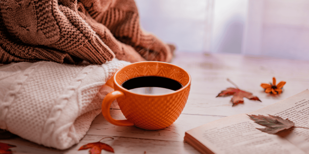 Cup of coffee in the fall to demonstrate the coziness of fall and why it's important to stay motivated in the fall