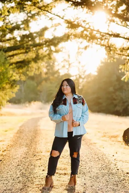 Kelly proudly displaying her custom jacket and demonstrating how you can start a business at any age